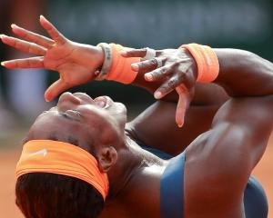 Serena Williams celebrates defeating Maria Sharapova to win the French Open at the Roland Garros...