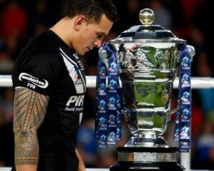 Sonny Bill Williams walks past the Rugby League World Cup trophy after the match. Photo Getty Images