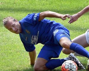 Southern United striker Sam French challenges for the ball with Team Wellington captain Cole...