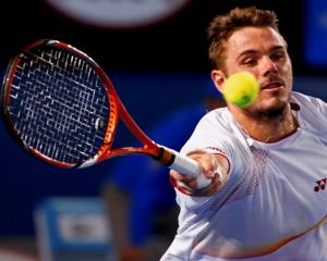 Stanislas Wawrinka hits a return to Tomas Berdych during their semifinal. REUTERS/Petar Kujundzic