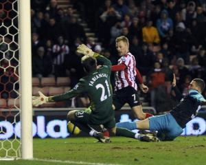 Sunderland's Sebastien Larsson (C) shoots to score against Arsenal during their FA Cup match in...