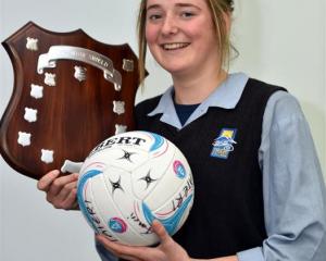 Taieri College netballer Rachel Beattie with the Lois Muir Shield, a trophy won by Taieri College...
