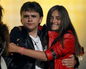 The children of late singer Michael Jackson, Prince Michael Joseph Jackson Jr. (L) and Paris...