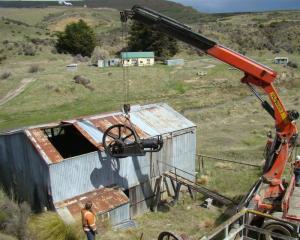 The gold stamp battery engine being lifted out of a historic building at Macraes mine on Thursday...