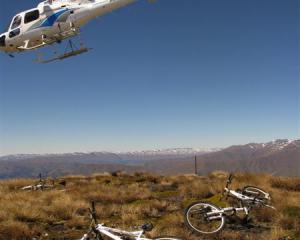 The helicopter that brought us up Crown Peak with our bikes departs for Queenstown Airport....