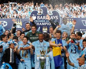 The Manchester City team celebrate winning the English Premier League following their match...