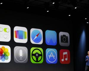 The new Apple iOS 7 features are displayed on screen  at Apple's  developers' conference in San...