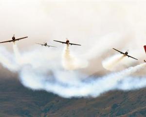 The Yak 52 team perform a starburst move. Photo by Stephen Jaquiery.