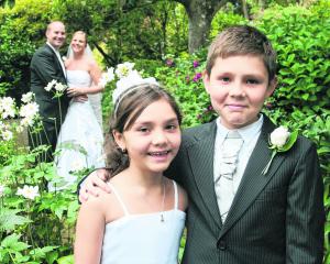 The young attendants, who are the bride's niece and nephew, at the wedding of Michaela...