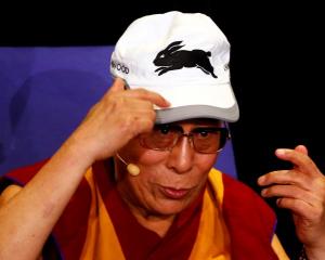 Tibetan spiritual leader the Dalai Lama wears a South Sydney Rabbitohs cap, which he was given,...