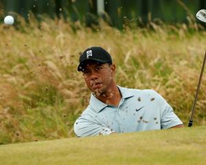 Tiger Woods practises on the chipping green ahead of the British Open Championship at the Royal...