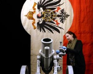 Toitu Otago Settlers Museum collections assistant Beth Rees adjusts a World War 1  German medium...