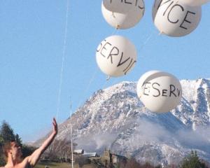 TVNZ weather man Sam Wallace displays his large MetService helium balloons during yesterday...
