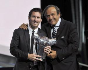 UEFA President Michel Platini (R) poses with Barcelona's Lionel Messi, who was named the Best...