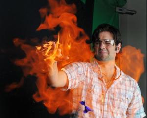 University of Otago chemistry PhD student Dan Hutchinson uses his flaming hand to burst and...