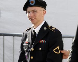 US Army Private First Class Bradley Manning (C) is escorted in handcuffs as he leaves the...