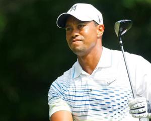 US golfer Tiger Woods watches his shot off the third tee during the first round of the Tour...