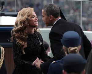 US President Barack Obama greets singer Beyonce after she performed the National Anthem during...