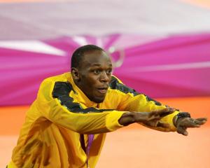 Usain Bolt celebrates after receiving his gold medal for the men's 4x100m relay. REUTERS/Gary...