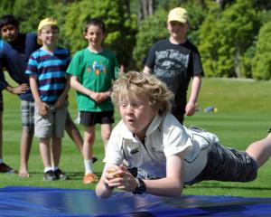 Xavier Chisholm (9), of Dunedin, waits for the impact as he dives to catch a cricket ball.