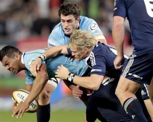 Waratahs' fullback Kurtley Beale, left, is tackled by Stormers' fullback Joe Pietersen. Stormers...