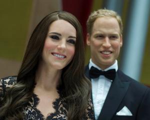 Wax figures of Kate Middleton, Duchess of Cambridge, and Prince William are displayed during a...