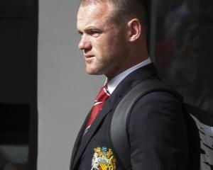 Wayne Rooney arrives at Thailand's Don Muang International Airport for Manchester United's...