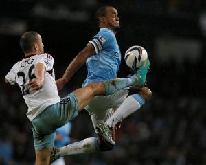 West Ham's Joe Cole (L) challenges Manchester City's Vincent Kompany. REUTERS/Phil Noble