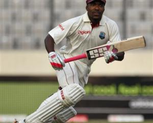 West Indies batsman Darren Bravo scores a run to make his first international century during the...