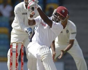 West Indies' Darren Bravo hits India's Harbhajan Singh for four during the fifth day of the...