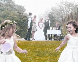 Young flowergirls enjoy free time during the signing of the register  at Melanie Sharp and James...