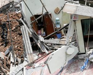 Members of the military work during a rescue mission after a garbage dump collapsed and buried dozens of houses in Colombo. Photo: Reuters