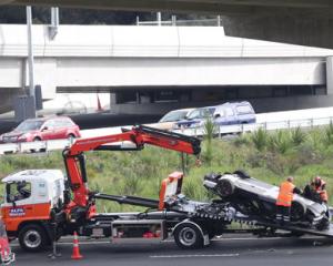 A McLaren supercar is loaded onto a recovery truck after an accident on the Great North Road on-ramp onto the Northwestern Motorway in Auckland. Photo: NZ Herald / Peter Meecham