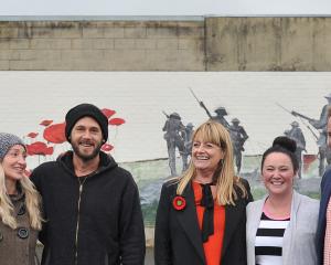 At a new Anzac-themed mural in Mosgiel yesterday are (from left) artists Tessa Petley and Daniel...