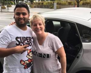 Lisa Kottke, her husband Matt, and "hero" Uber driver Harpal Kang who drove them from Auckland to Wellington over nine and a half hours for an urgent meeting after flights were cancelled due to Cyclone Debbie. Photo: NZ Herald