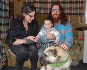 Liz Boyle and Joel Rowlands with their son, Rhythm, and dog Bossco at their rented home at...