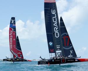 Oracle Team USA skippered by Jimmy Spithill in action racing against Emirates Team New Zealand...