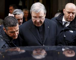 Australian Cardinal George Pell leaves at the end of a meeting with the victims of sex abuse in...