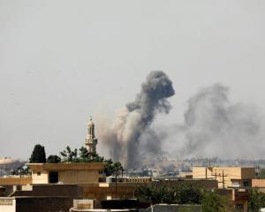 Smoke rises from an air strike by Iraqi forces towards Islamic State militants in the Old City of...