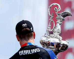 Peter Burling, Emirates Team New Zealand Helmsman holds the America's Cup after defeating Oracle...