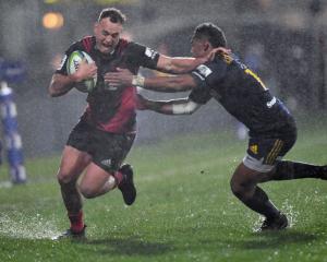 Israel Dagg of the Crusaders is tackled by Waisake Naholo of the Highlanders. Photo: Getty