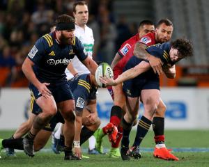 Richard Buckman (R) of the offloads the ball to team mate Liam Coltman of the Highlanders. Photo:...