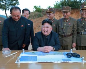 North Korean leader Kim Jong Un reacts during the long-range strategic ballistic rocket Hwasong...
