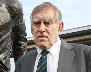 Sir Colin Meads in front of the statue of himself in June in Te Kuiti. Photo: NZ Herald.