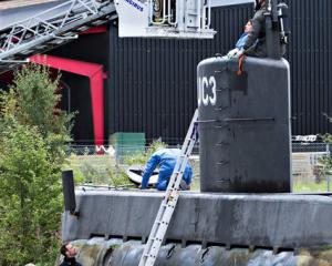 Police technicians investigate the rescued private submarine "UC3 Nautilus" in Copenhagen. Photo:...