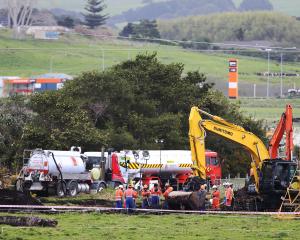 New Zealand Refinery staff at the site of a fuel pipeline leak on farm land between State Highway...