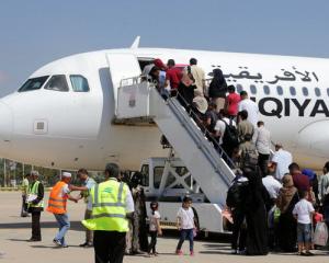 Passengers board a flight at Benina airport east of Benghazi in Libya. Photo: Reuters