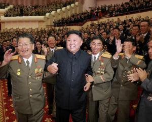 North Korean leader Kim Jong Un reacts during a celebration for nuclear scientists and engineers...