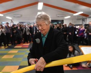 Years of effort ... Library lobbyist and former city councillor Anne Turvey cuts the ribbon to...