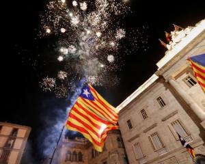 Fireworks go off in front of the Catalan regional government headquarters during celebrations...